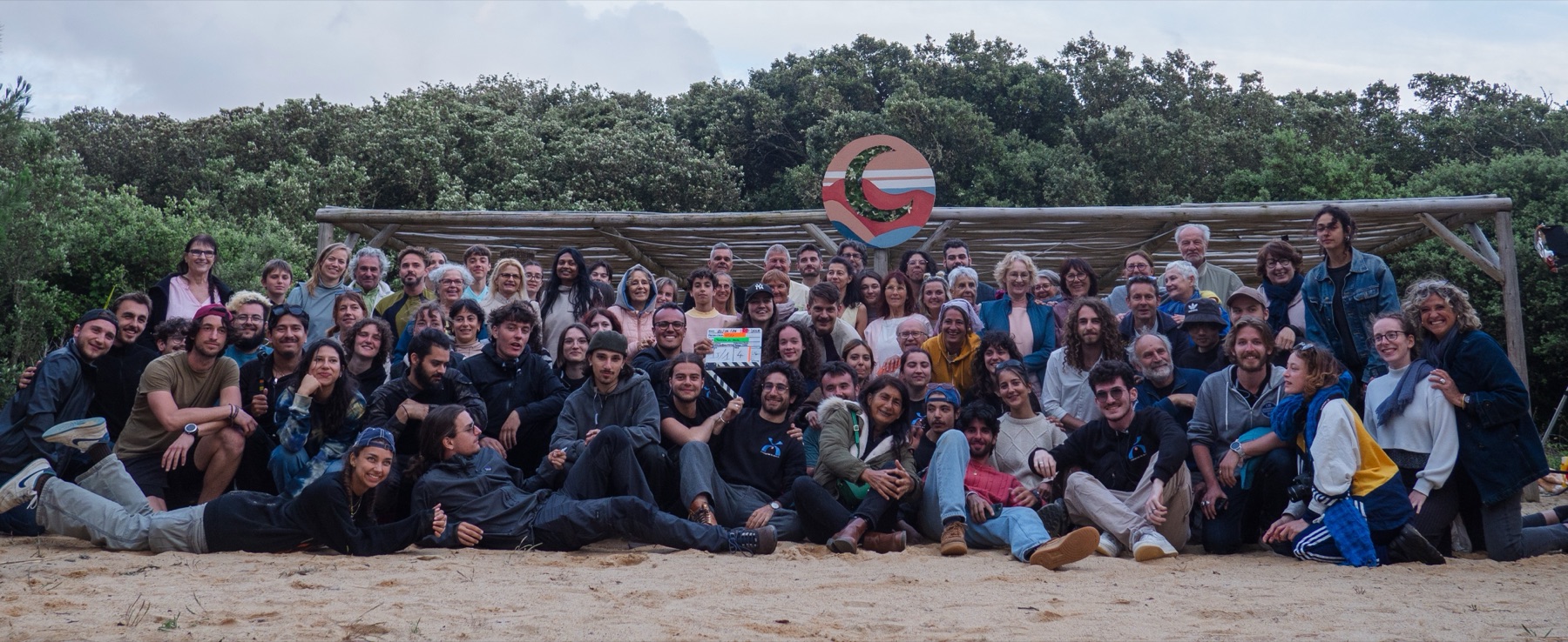 The short film's team and extras gathered on the shooting beach, under the La Pointe Rose totem